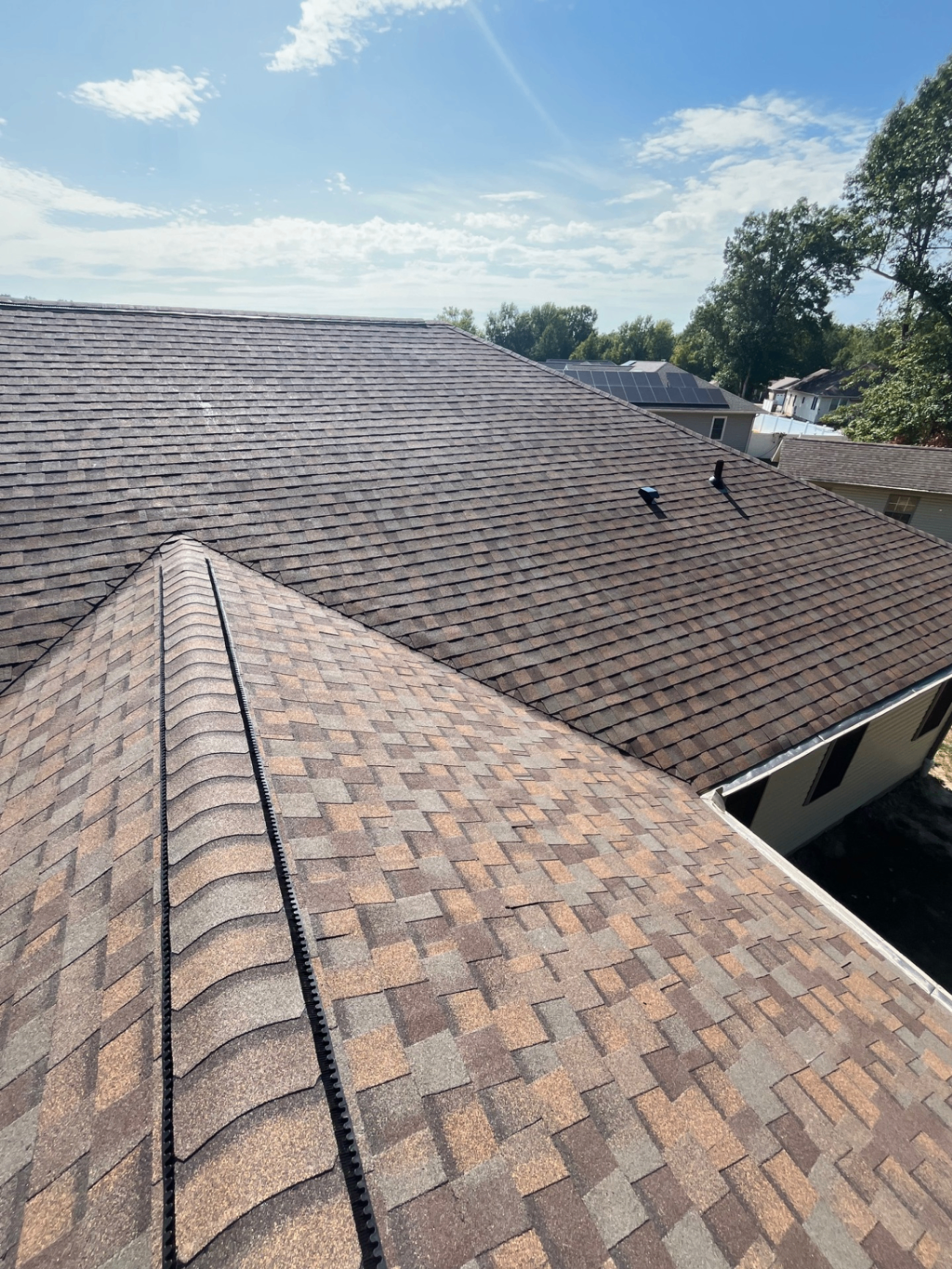 Cobblestone neutral-tone architectural asphalt shingles on a completed roof