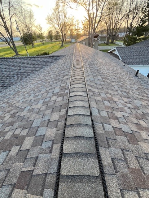 Moire Black architectural asphalt shingles at sunset on a residential roof